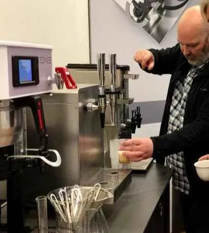 Man pouring Yorkshire Coffee Liqueur from NORSE CODE dispenser.