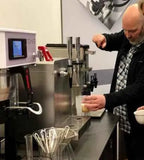Man pouring Yorkshire Coffee Liqueur from NORSE CODE dispenser.