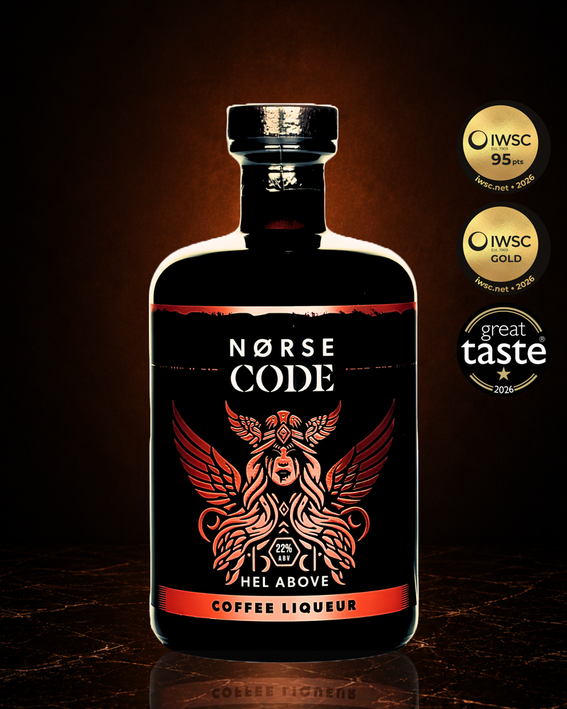 Bottle of Norse Code Hel Above coffee liqueur on a dark background with a warm amber glow, featuring the IWSC Gold 95 Points 2026, IWSC Gold 2026 and Great Taste 2026 award badges. Premium Yorkshire coffee liqueur made from real brewed coffee for Espresso Martinis.