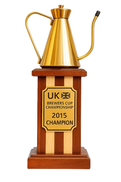 Trophy with a gold pitcher on a wooden base, awarded for UK Brewers Cup Championship 2015 Champion.