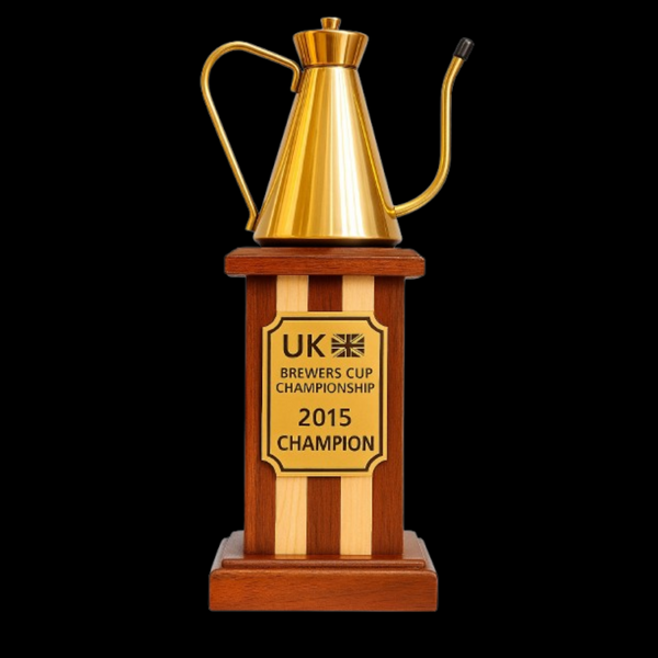 Trophy with a gold coffee pot on a wooden base, featuring 'UK Brewers Cup Championship 2015 Champion' text.